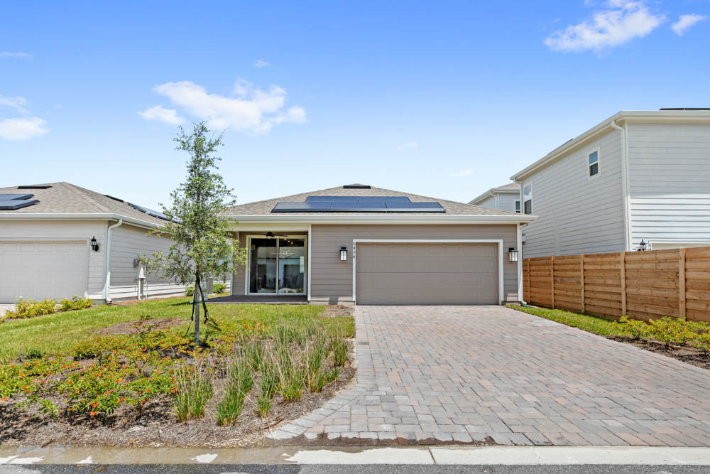 back of home with two car garage and long driveway
